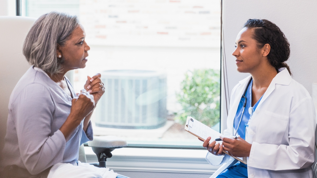 an older female patient discussing her health concerns with her doctor during her annual wellness checkup
